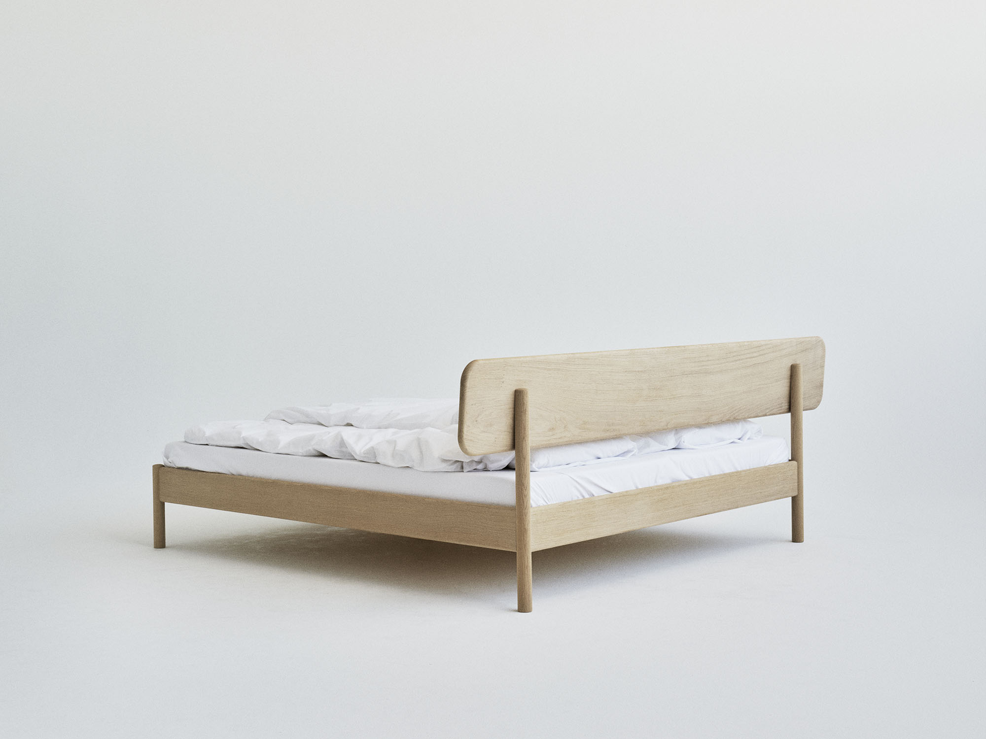 RYE Alken bed frame in soaped solid oak - back view pack shot