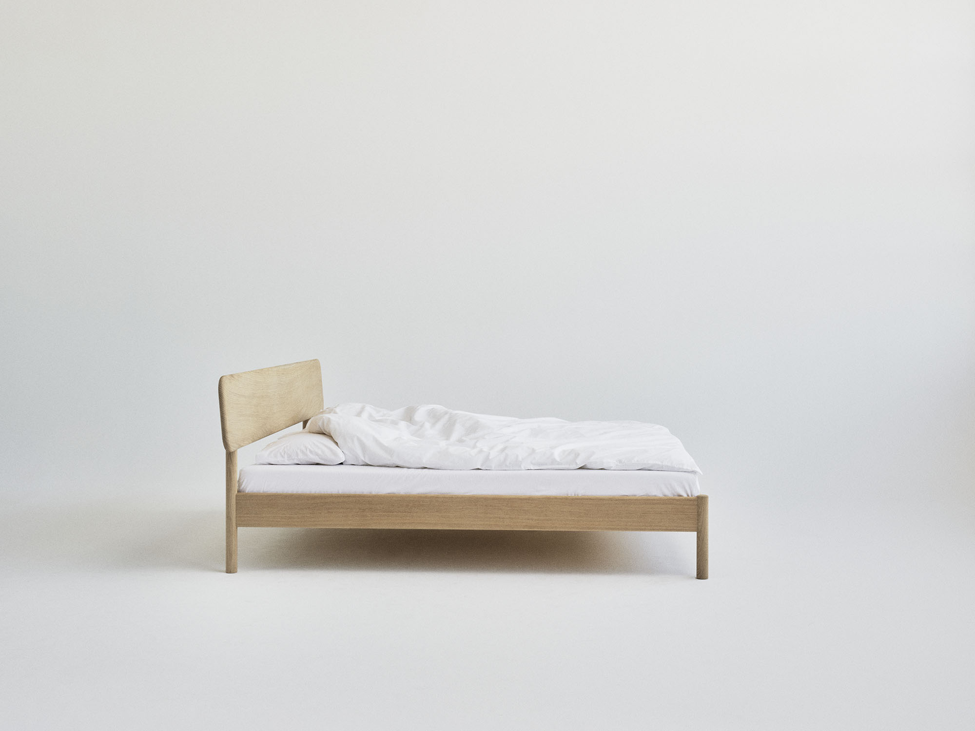 RYE Alken bed frame in soaped solid oak - side view pack shot