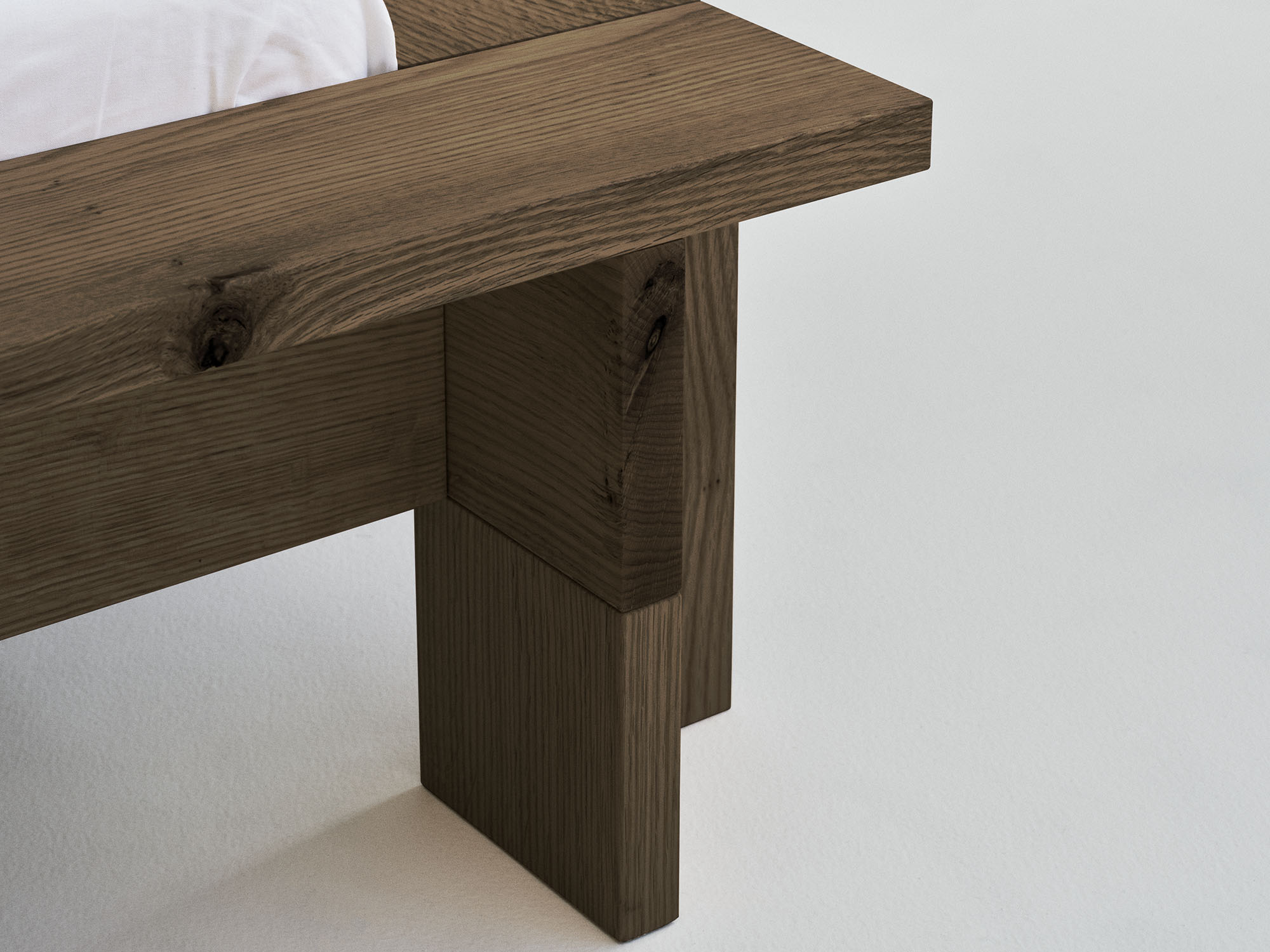 RYE Hem bed frame in smoked solid red oak - footed detail pack shot