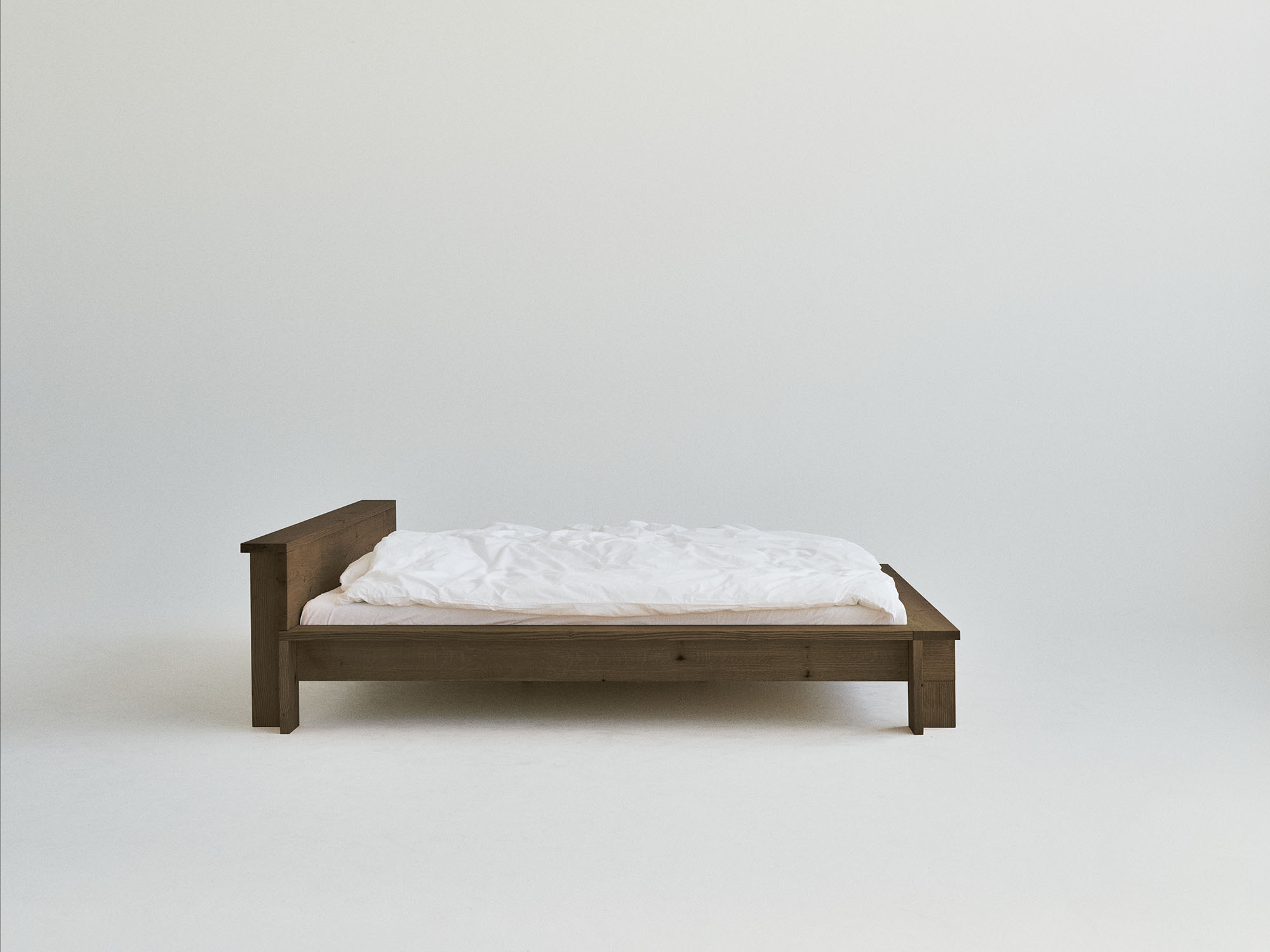 RYE Hem bed frame in smoked solid red oak - side view pack shot